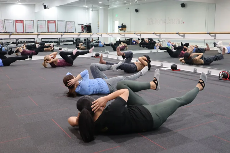 Group fitness class working out together in a gym