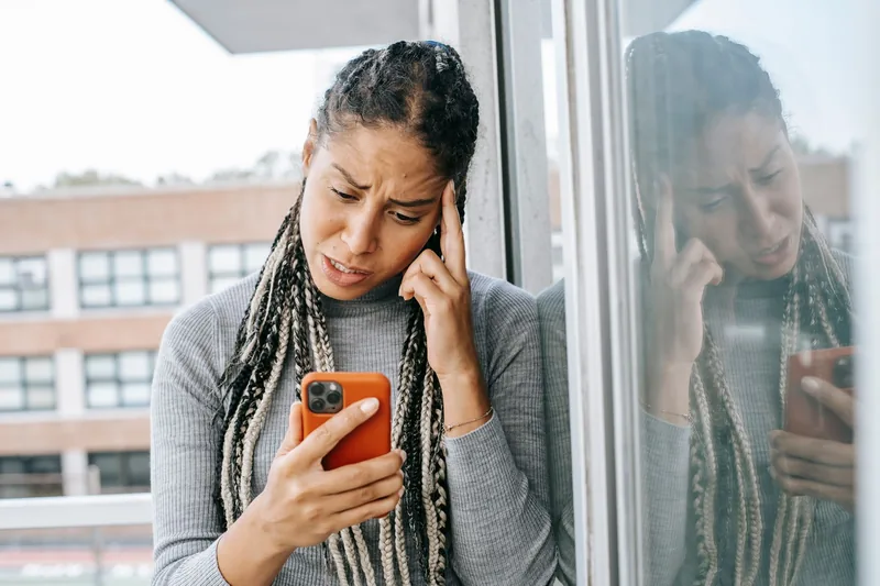 Frustrated woman waiting for a website to load on her smartphone