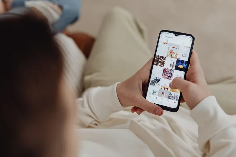 Person scrolling an Instagram feed on a smartphone