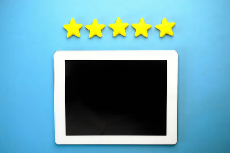 Five yellow stars above a tablet on a blue background, representing customer reviews