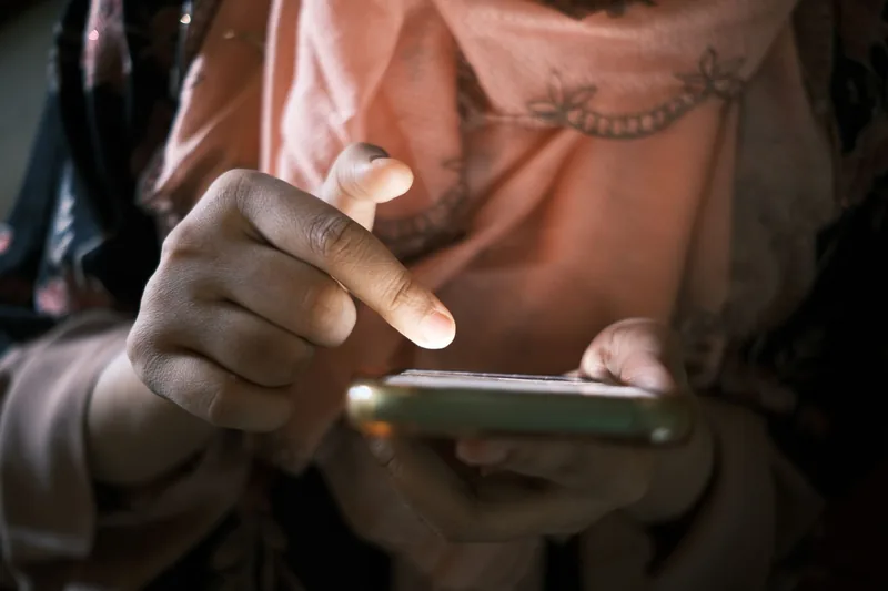 Person scrolling through short videos on a smartphone