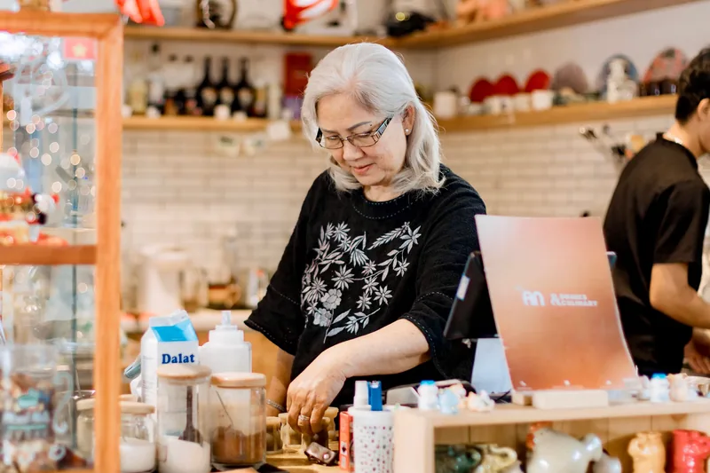 Small business owner working behind the counter of a shop