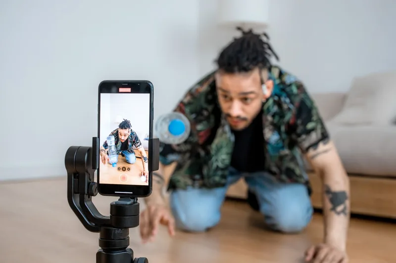 Small business owner filming a product video on a phone mounted to a tripod