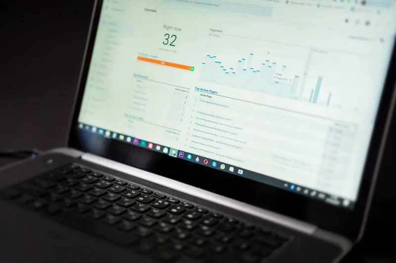 Laptop screen showing a website analytics dashboard with real-time visitors and page views